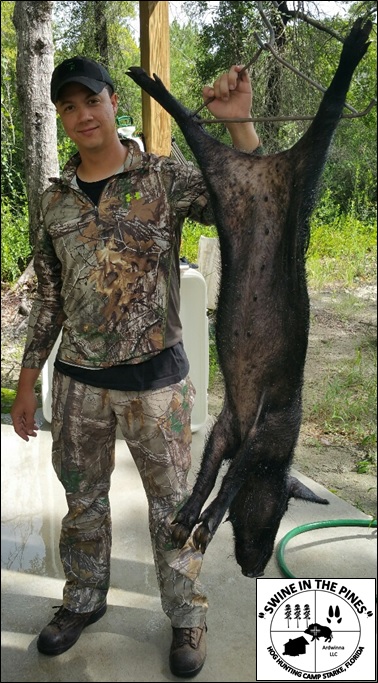 Hector is stocking his freezer with Wild Hogs from Swine In The Pines Hog Hunting Camp