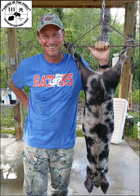 Kevin with his Wild Hog taken at Swine In The Pines Hog Hunting Camp